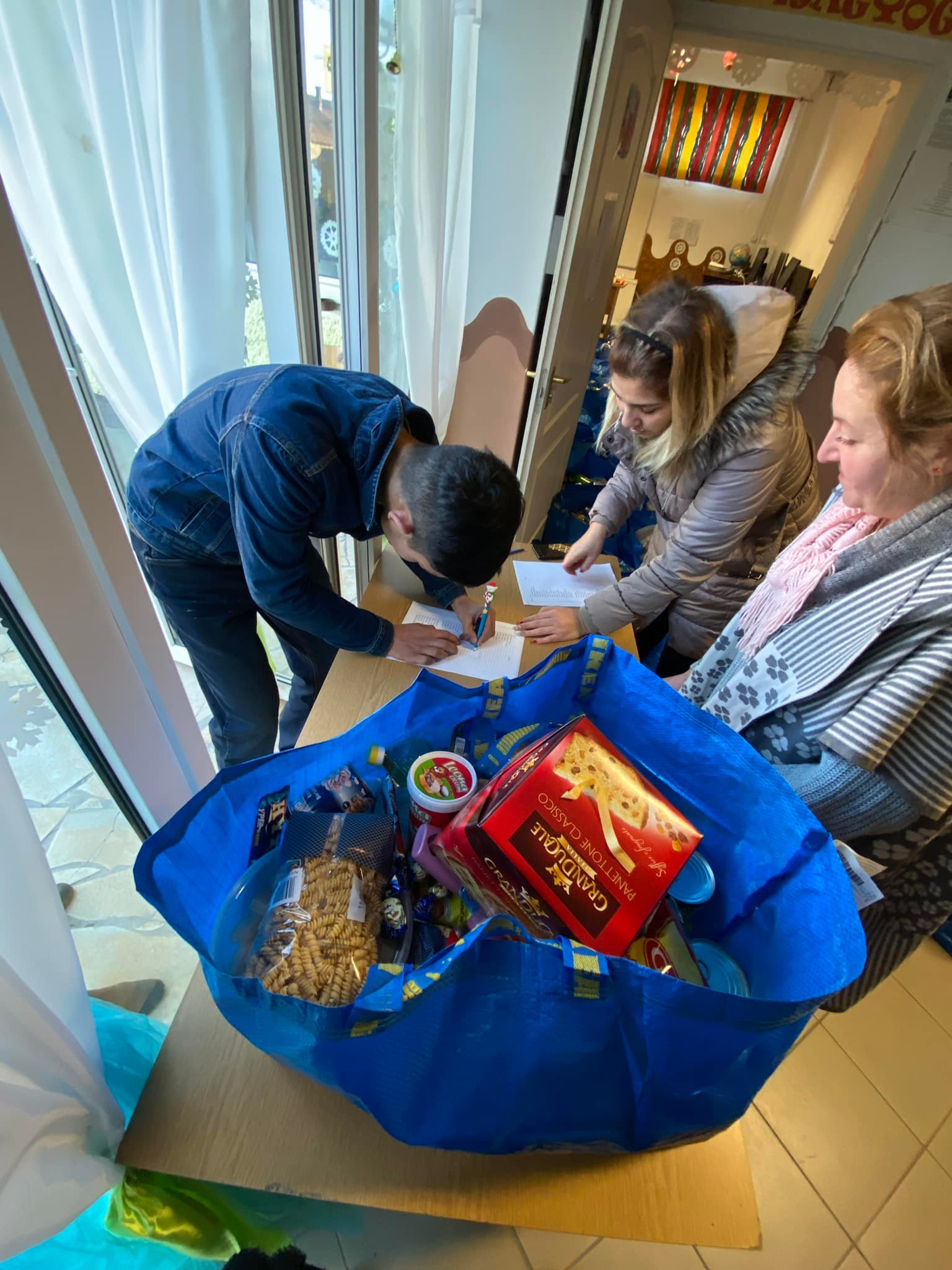 In the picture, a boy is receiving a food package